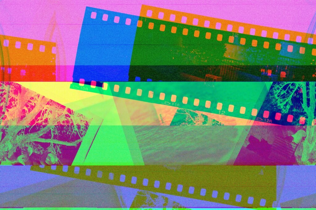 Vibrant display of overlapping photographic film rolls in abstract colors.