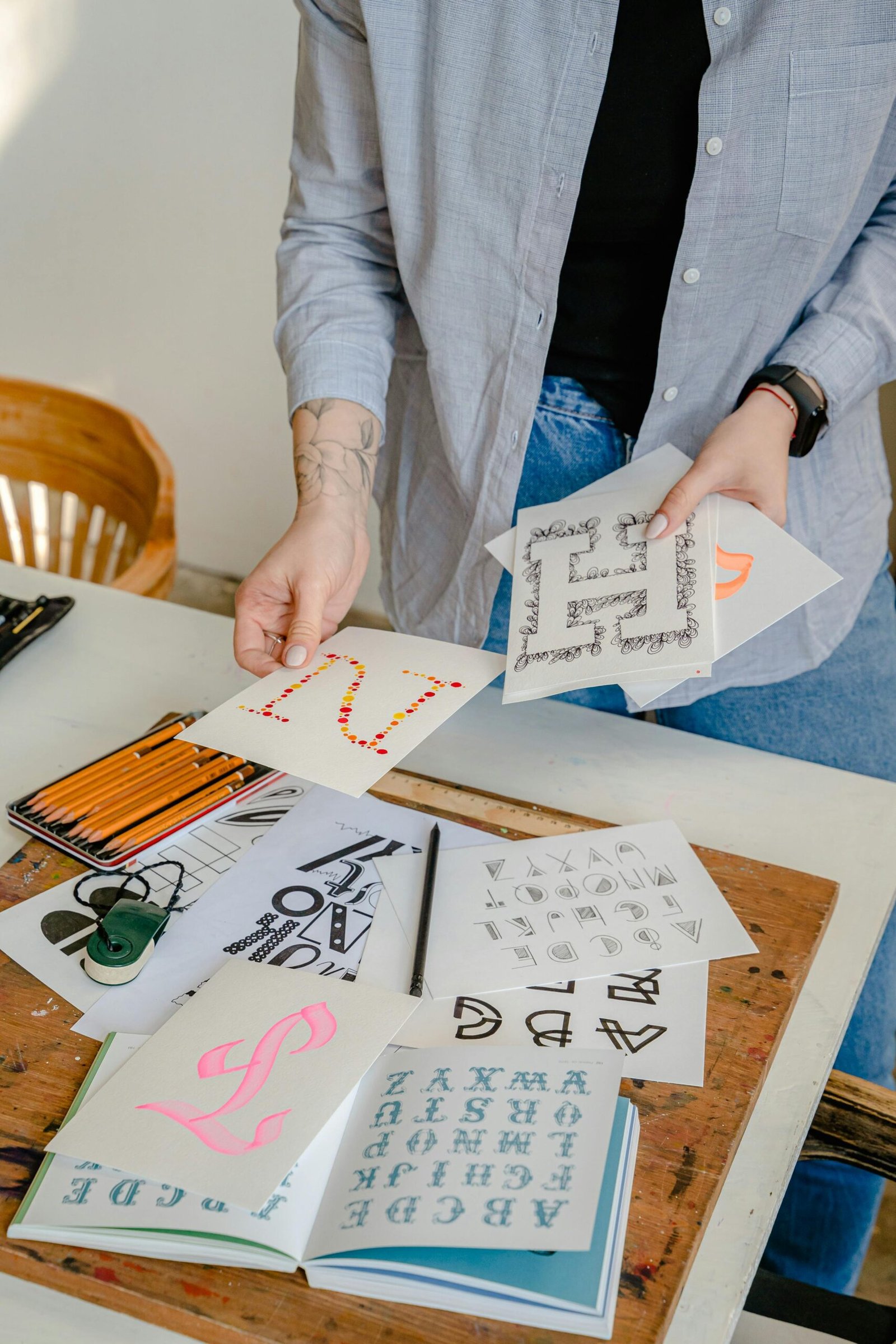 A creative workspace showcasing calligraphy tools, lettering projects, and artistic supplies.