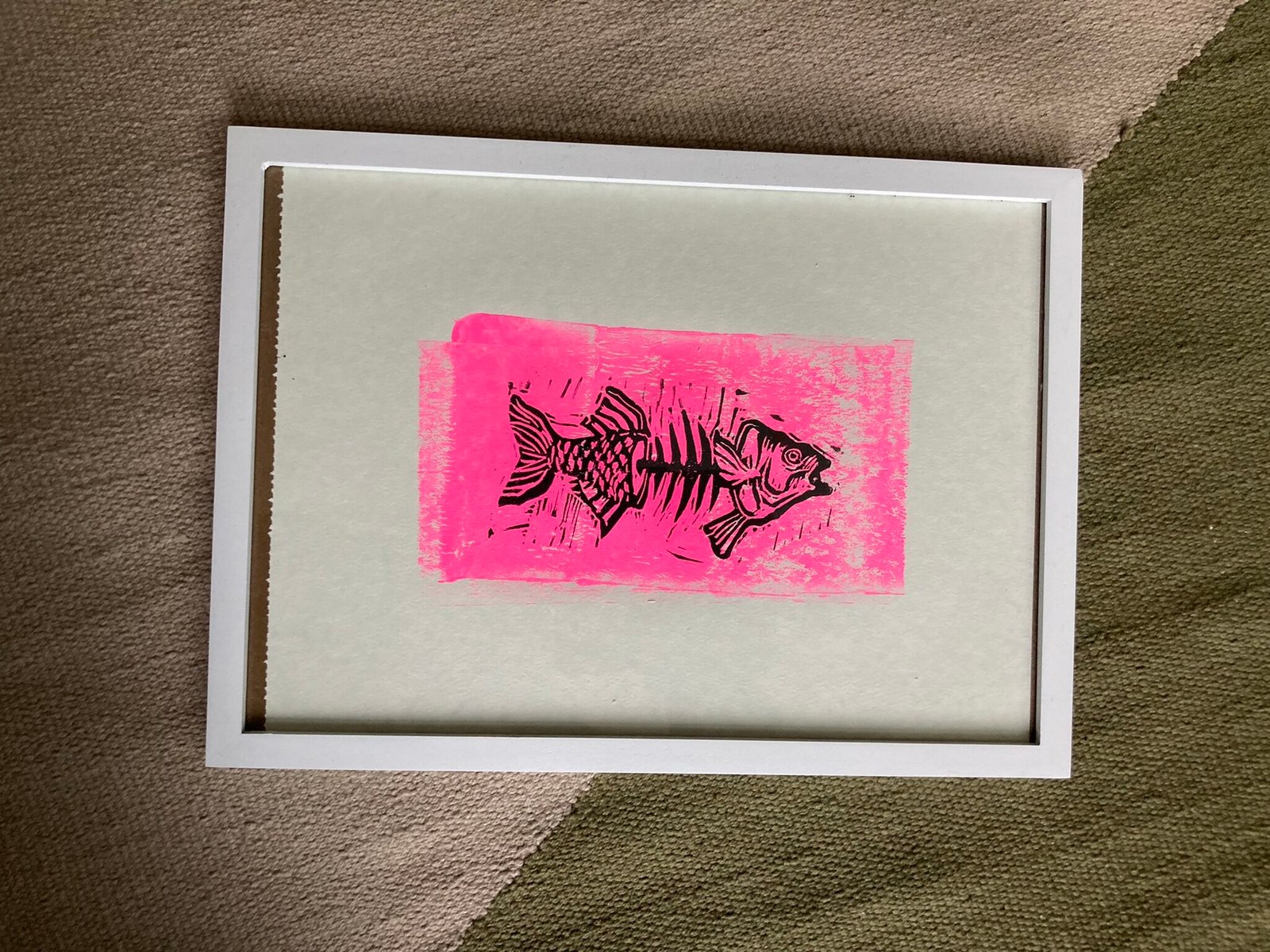 A5 Linoprint Black skeletal fish on fluorescent pink rectangle